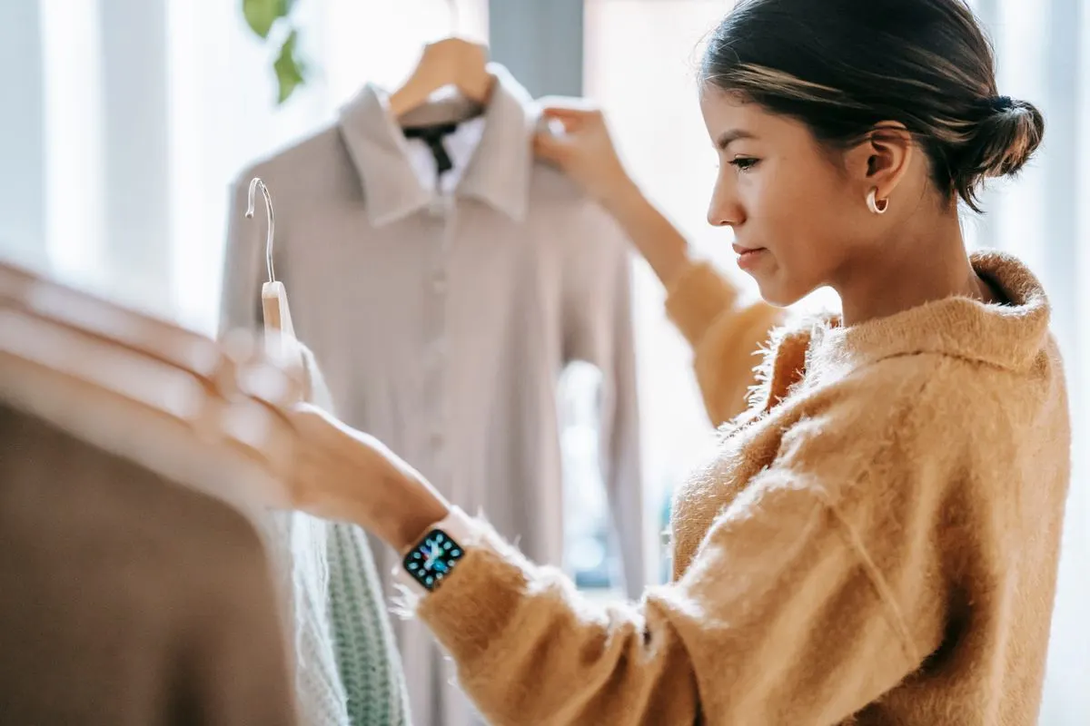 Woman comparing garments on hangers
